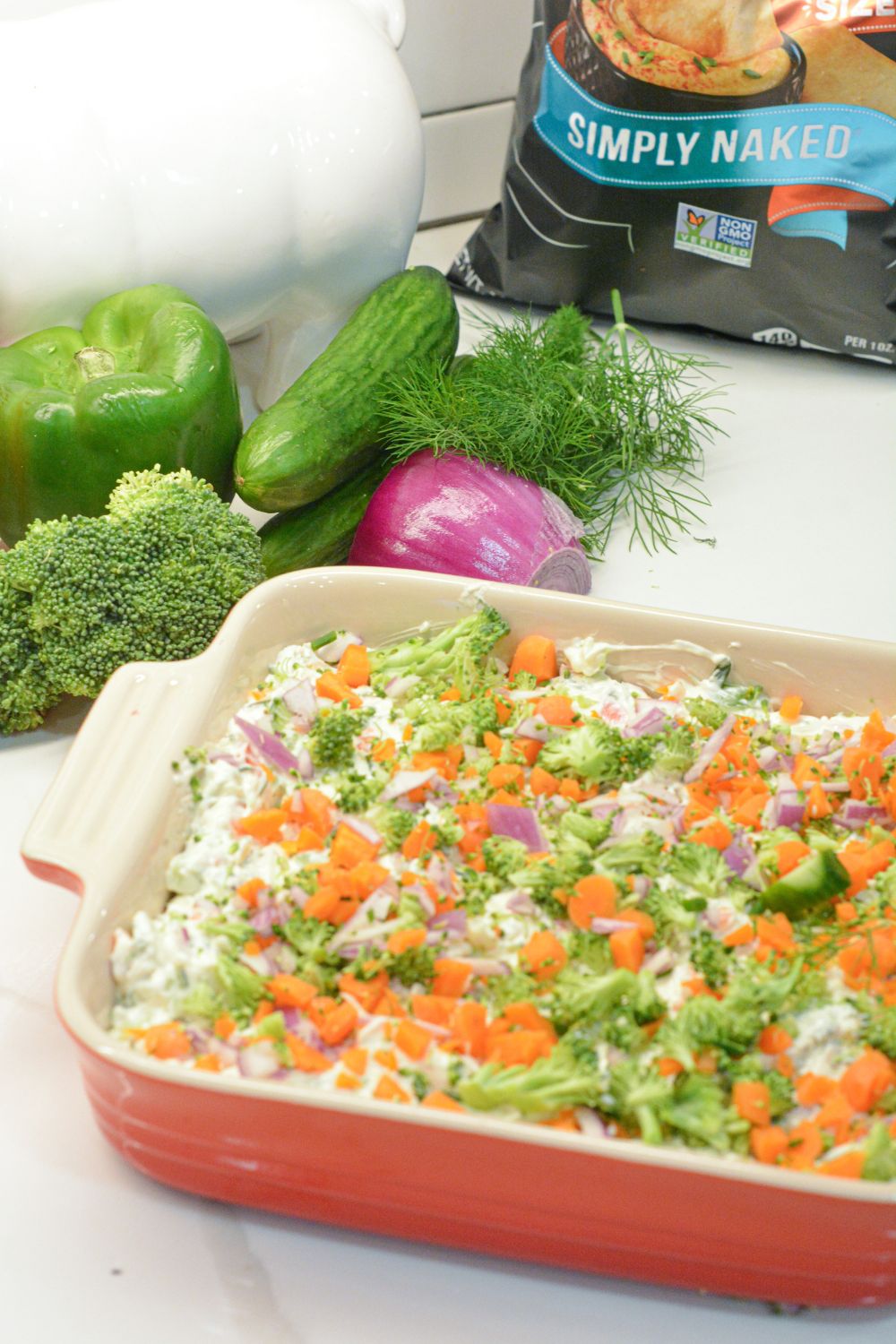 This easy veggie pizza dip is a creamy, no-bake appetizer made with cream cheese, ranch, cheddar cheese, and fresh chopped veggies. Perfect for parties, potlucks, and game day!