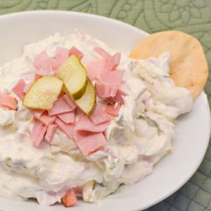 This creamy pickle wrap dip made with deli ham, cream cheese, and dill pickles is the ultimate party appetizer. All the flavor of classic pickle wraps without the work!