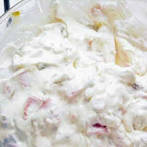 Add in the chopped pickles, deli ham, and dill. Mix well until everything is evenly coated in the creamy base.