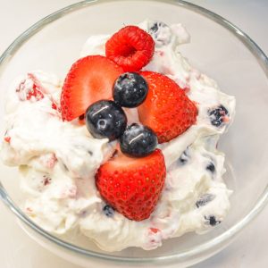 This easy Berry Cheesecake Salad recipe is made with cheesecake pudding mix, cream cheese, vanilla Greek yogurt, whipped topping, and fresh berries. A creamy no-bake dessert salad perfect for summer parties, potlucks, and holidays!