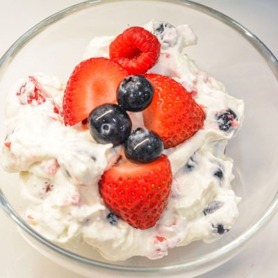 This easy Berry Cheesecake Salad recipe is made with cheesecake pudding mix, cream cheese, vanilla Greek yogurt, whipped topping, and fresh berries. A creamy no-bake dessert salad perfect for summer parties, potlucks, and holidays!