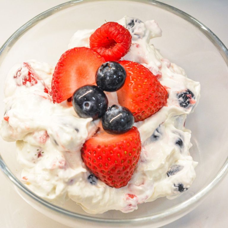 This easy Berry Cheesecake Salad recipe is made with cheesecake pudding mix, cream cheese, vanilla Greek yogurt, whipped topping, and fresh berries. A creamy no-bake dessert salad perfect for summer parties, potlucks, and holidays!