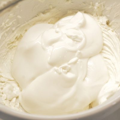In a large mixing bowl, beat the cream cheese. Then mix the cheesecake pudding mix, vanilla Greek yogurt, and vanilla extract into the cream cheese until smooth and thick.