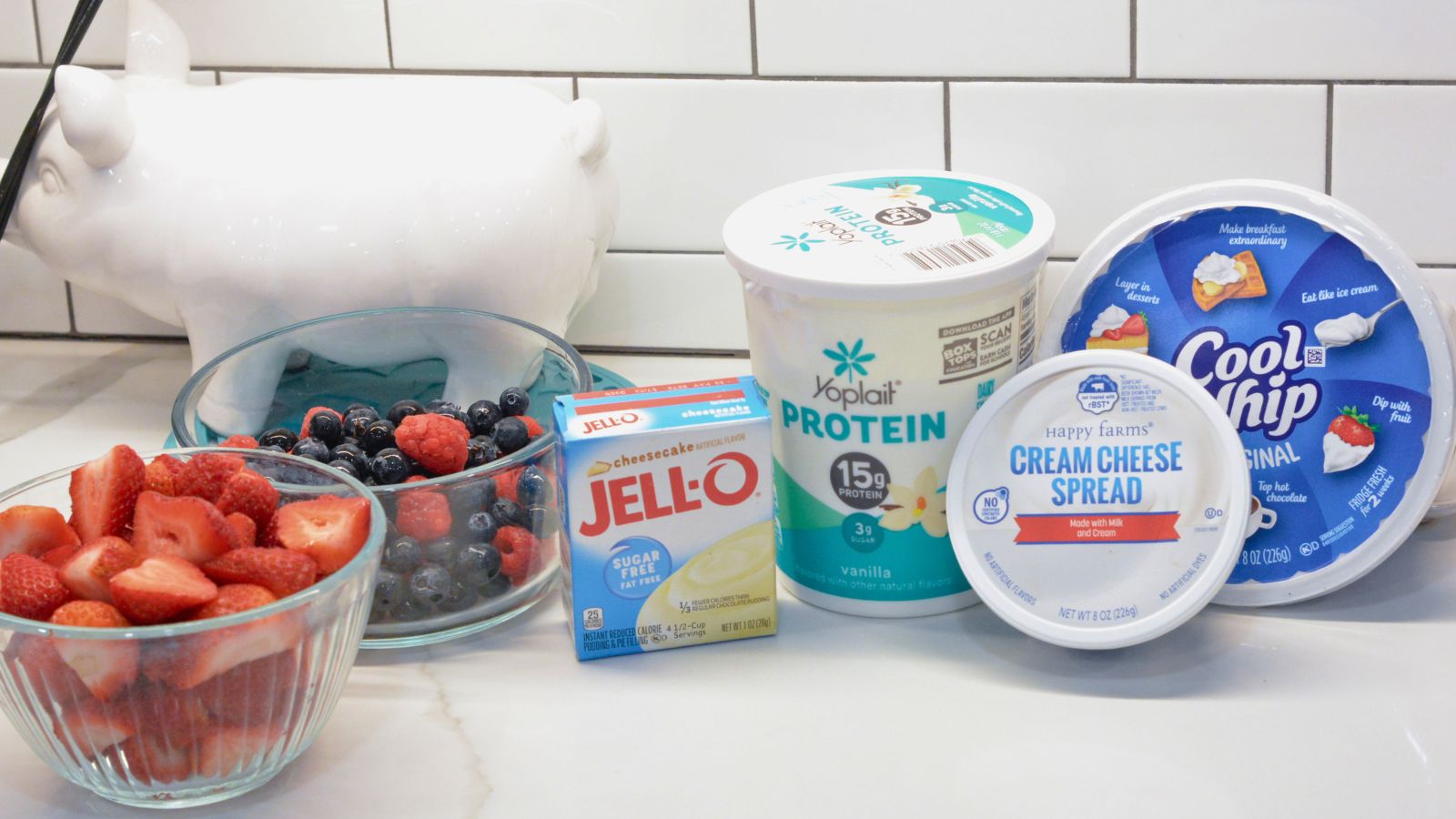 1 (3.4 oz) box cheesecake instant pudding mix (dry mix only)
1 cup vanilla Greek yogurt or high-protein yogurt
1/2 cup whipped cream cheese
8 oz whipped topping (such as Cool Whip), thawed
1 cup fresh strawberries, sliced
1 cup fresh blueberries
1 cup fresh raspberries
Optional: 1 banana, sliced (add just before serving to avoid browning)
Optional garnish: crushed graham crackers or mini marshmallows