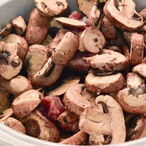 Top with onion, garlic, and sliced mushrooms.
