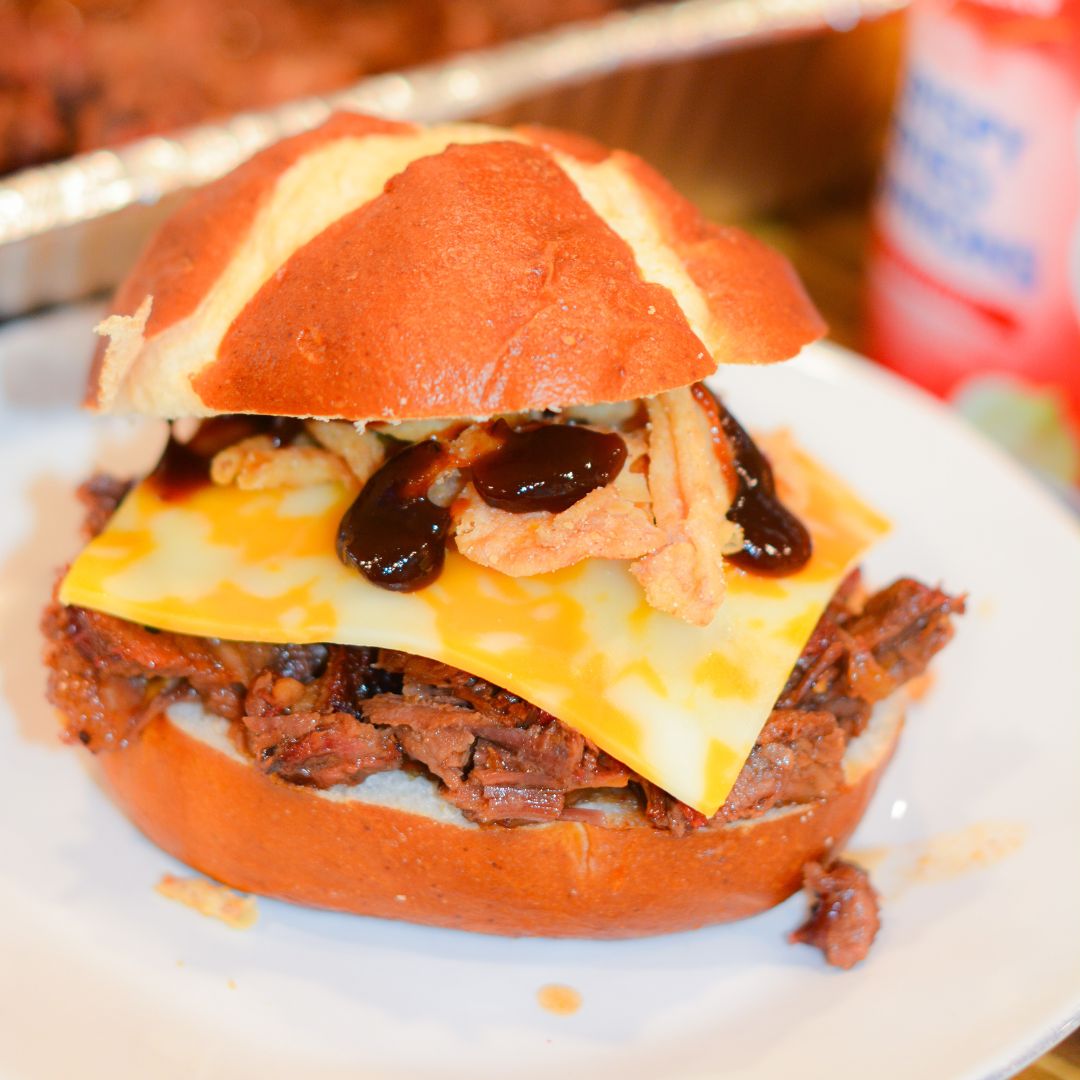 Make hearty Smoked Cowboy Beef Sandwiches with tender chuck roast, barbecue seasoning, and a rich sauce—smoked or slow-cooked in the crock pot, then piled high with cheese, bacon, fried onions, and pickles.