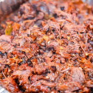Remove the beef and shred with two forks. Return the shredded beef to the braising liquid, add one cup of barbecue sauce, and stir to coat.