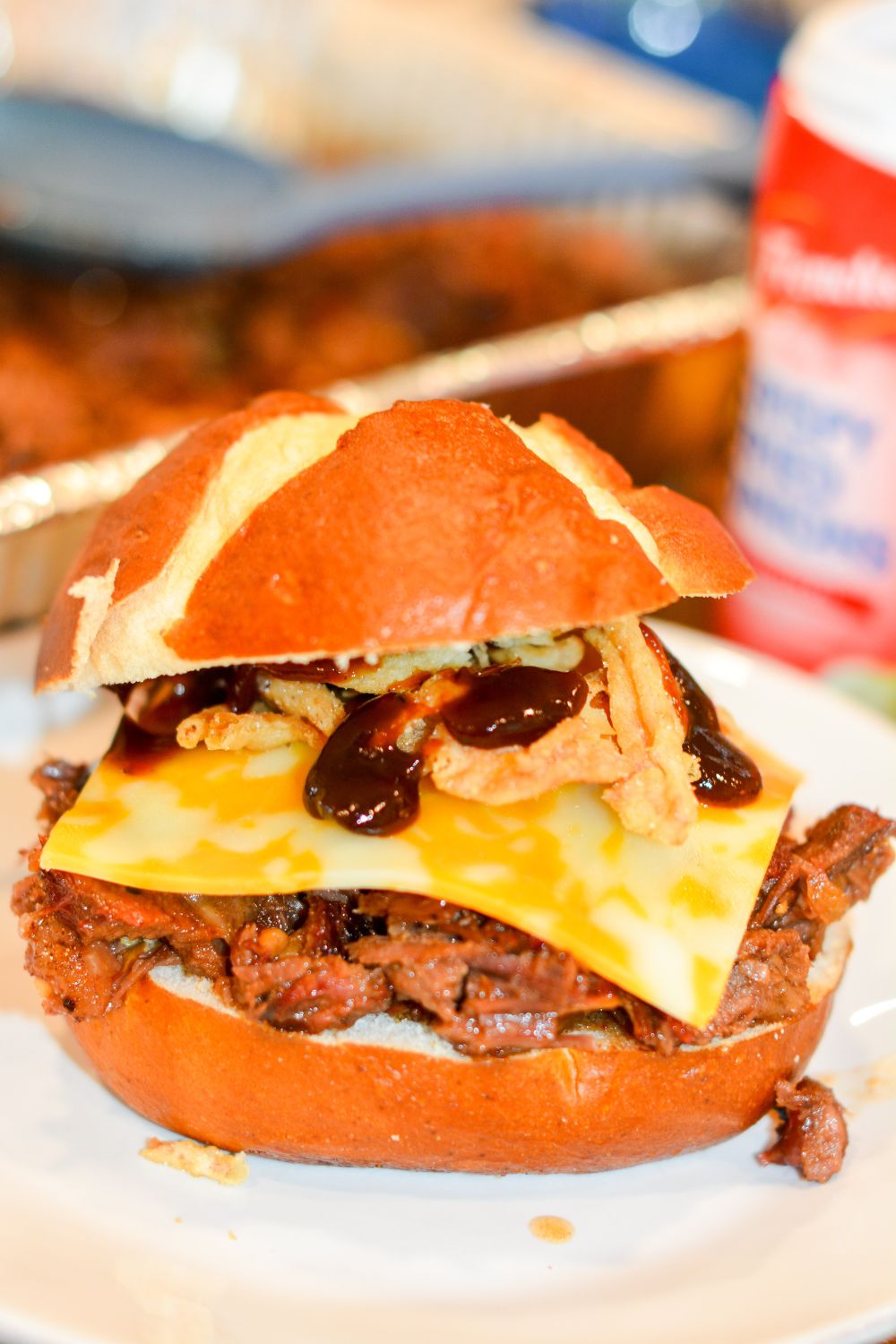 Make hearty Smoked Cowboy Beef Sandwiches with tender chuck roast, barbecue seasoning, and a rich sauce—smoked or slow-cooked in the crock pot, then piled high with cheese, bacon, fried onions, and pickles.