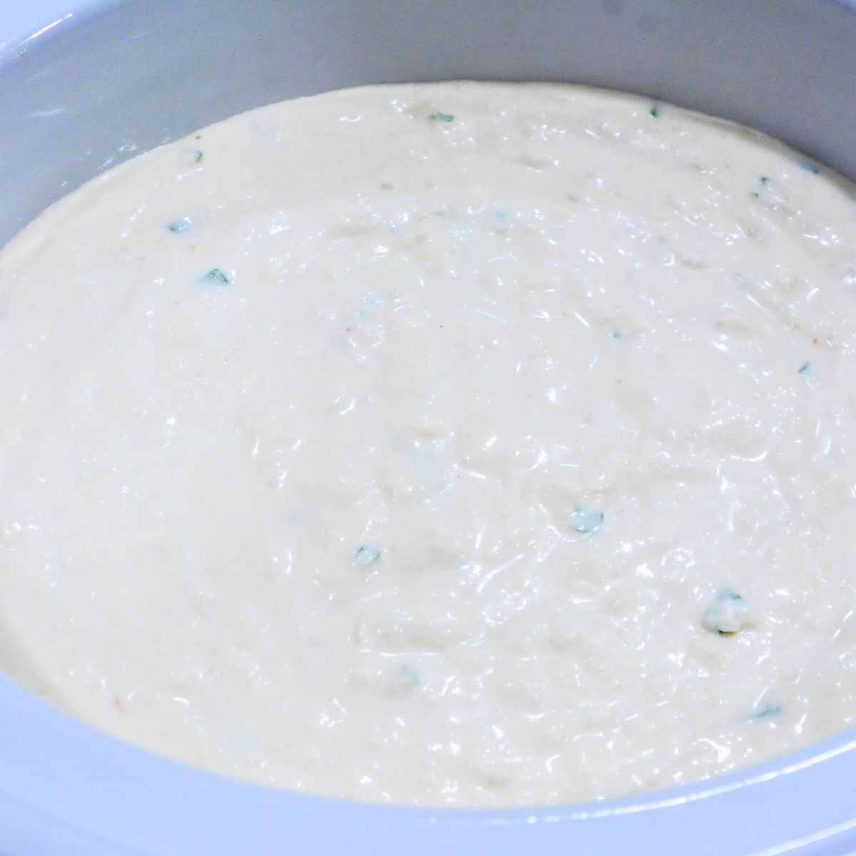 Transfer the mixture to the slow cooker and spread evenly.