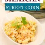 Creamy Mexican street corn salad in a white bowl topped with cotija cheese and cilantro