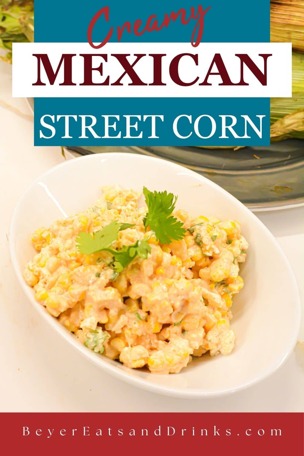 Creamy Mexican street corn salad in a white bowl topped with cotija cheese and cilantro