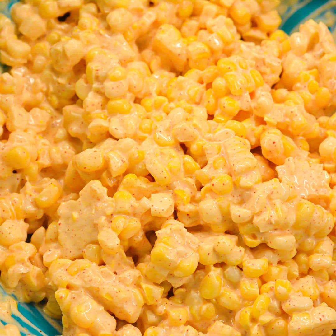 Corn kernels coated in creamy chipotle dressing before adding cheese