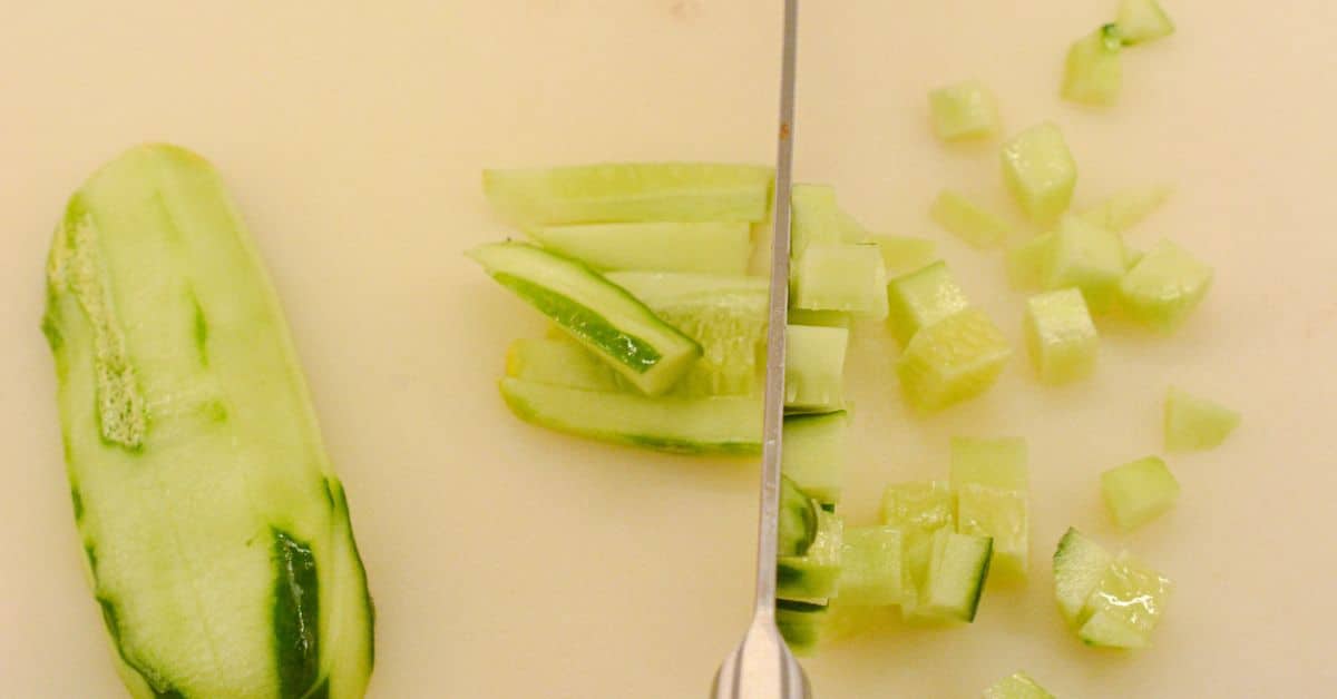 Cucumber sliced into strips then diced into small pieces for cucumber salsa